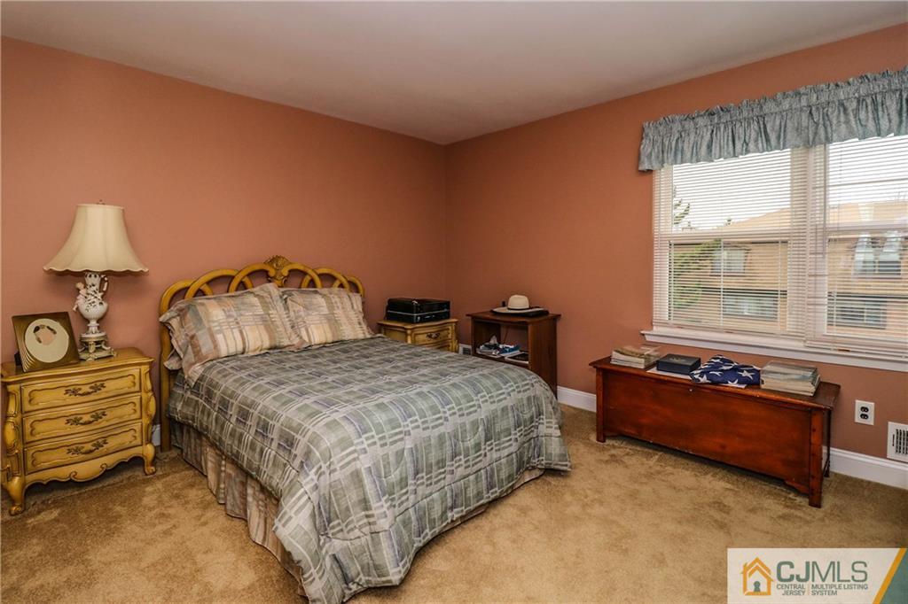 7307 Hana Road Edison, NJ 08817 - Photo 16 of 24 a bedroom with a bed and window