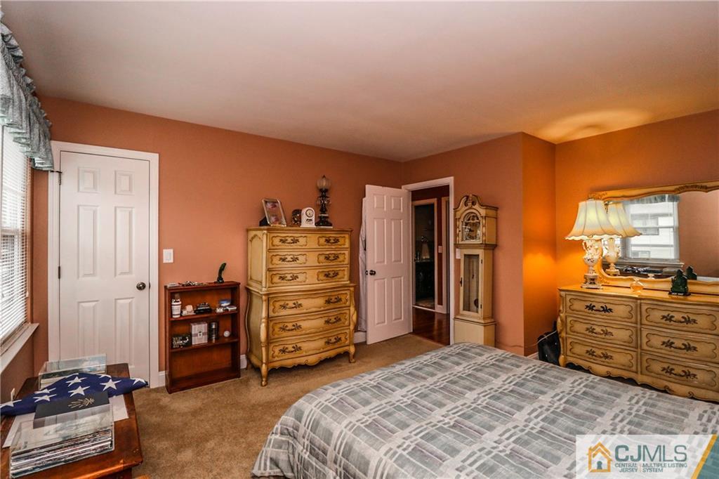 7307 Hana Road Edison, NJ 08817 - Photo 17 of 24 a bedroom with a bed and furniture
