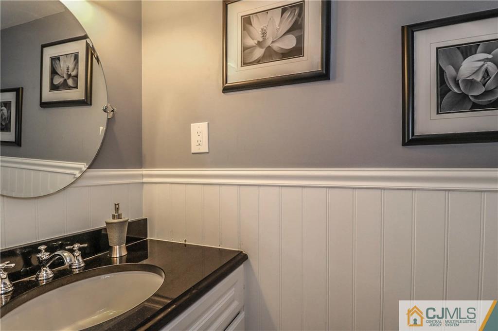 7307 Hana Road Edison, NJ 08817 - Photo 19 of 24 a bathroom with a sink and a mirror