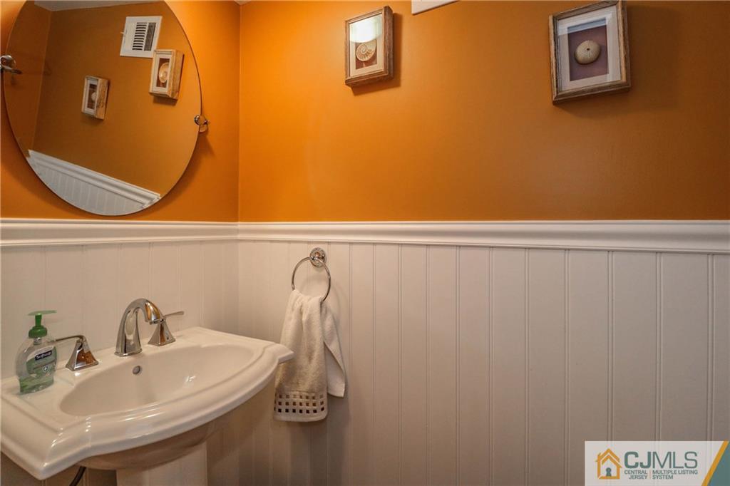 7307 Hana Road Edison, NJ 08817 - Photo 20 of 24 a bathroom with a sink and a mirror