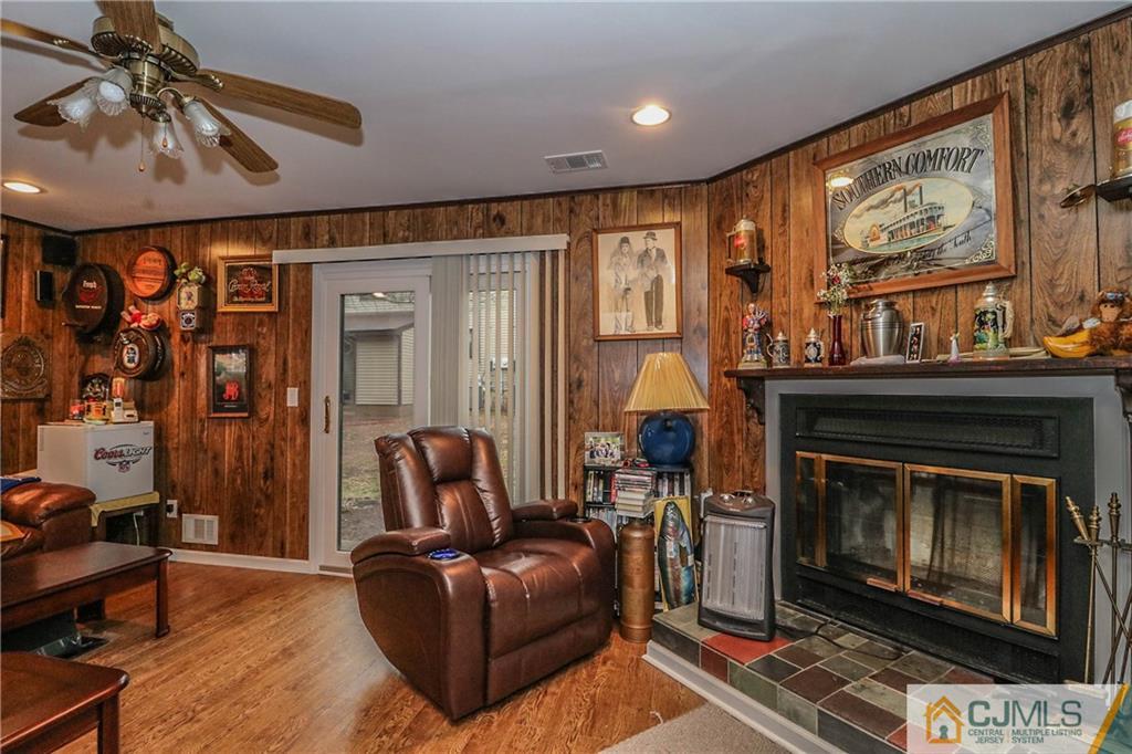7307 Hana Road Edison, NJ 08817 - Photo 22 of 24 a living room with furniture a flat screen tv and a fireplace