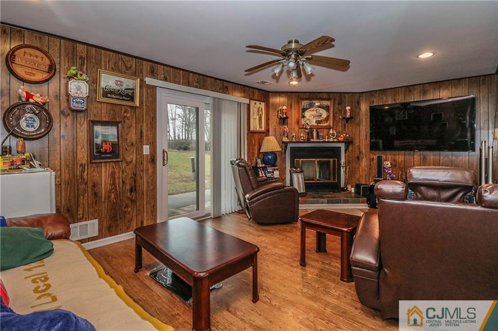 7307 Hana Road Edison, NJ 08817 - Photo 23 of 24 a living room with furniture a flat screen tv and a fireplace