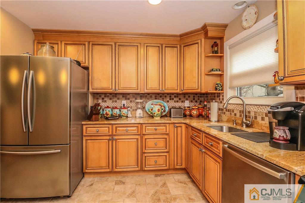 7307 Hana Road Edison, NJ 08817 - Photo 8 of 24 a kitchen with stainless steel appliances granite countertop a refrigerator sink and cabinets