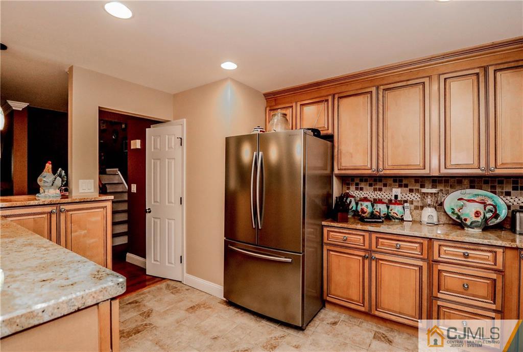 7307 Hana Road Edison, NJ 08817 - Photo 9 of 24 a kitchen with stainless steel appliances granite countertop a refrigerator stove and sink
