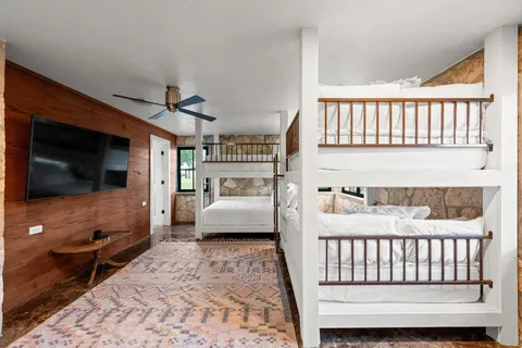 a bedroom with furniture and a flat screen tv