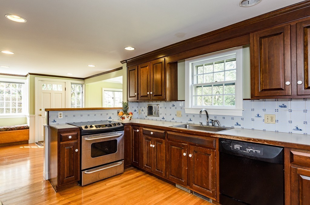 68 Old Farm Road Newton, MA 02459 - Photo 6 of 23 a kitchen with stainless steel appliances granite countertop a sink stove and cabinets