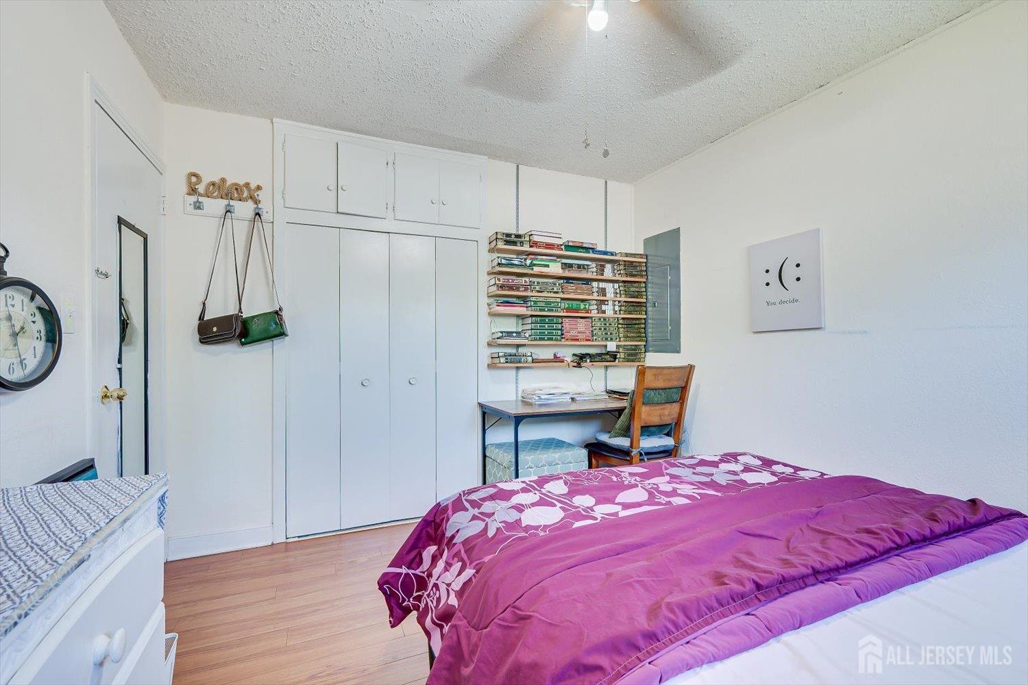 15 Markham Road Edison, NJ 08817 - Photo 23 of 32 a bedroom with a bed a chandelier and a dresser