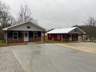 138 Mathews Road Oneida, TN 37841 - Photo 18 of 31 a front view of a house with a yard and garage