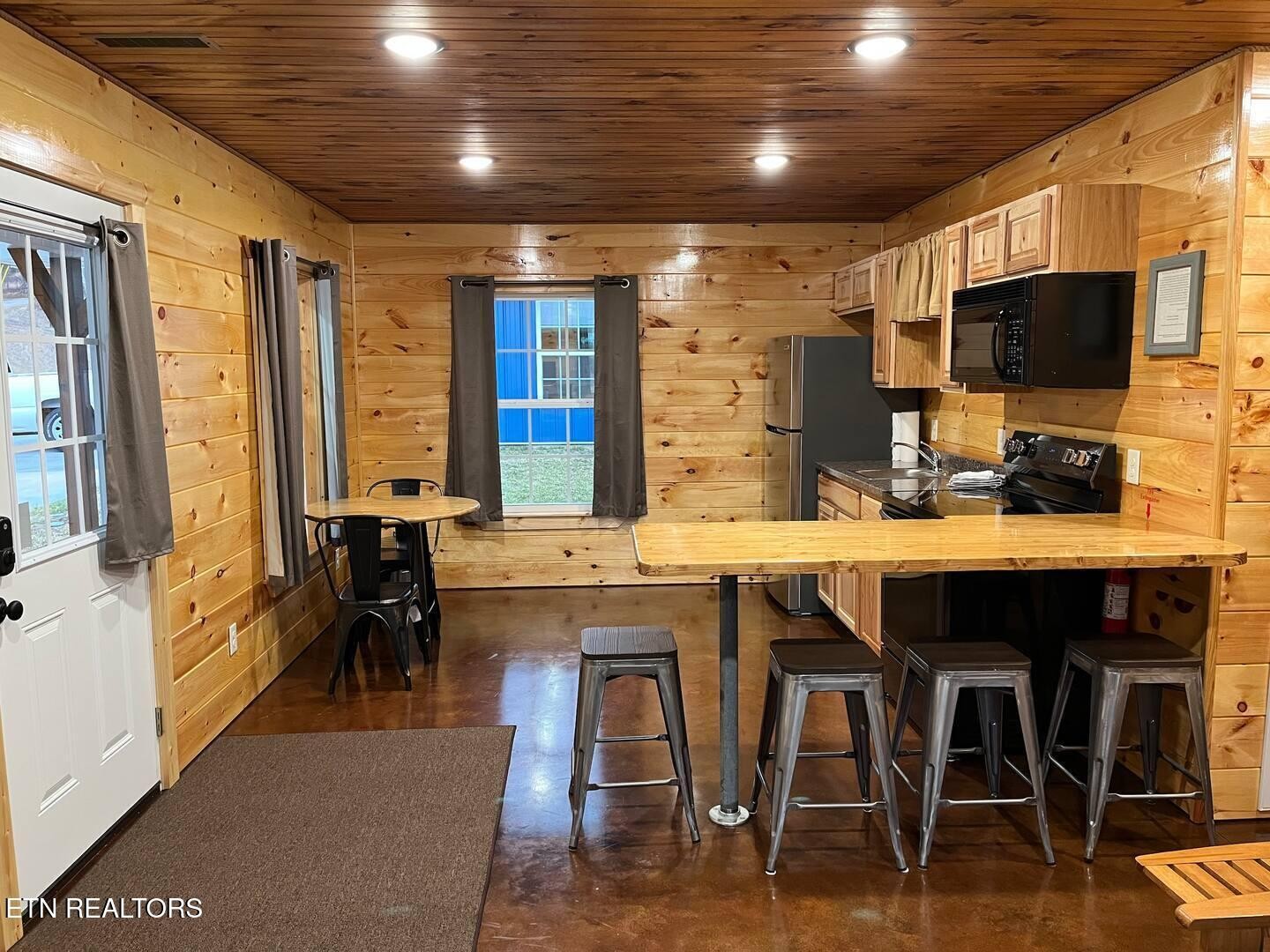 138 Mathews Road Oneida, TN 37841 - Photo 4 of 31 a kitchen with a table chairs sink and cabinets