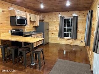 138 Mathews Road Oneida, TN 37841 - Photo 5 of 31 a kitchen with stainless steel appliances granite countertop a stove top oven a sink a dining table and chairs with wooden floor
