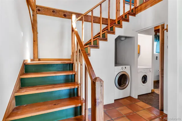a view of entryway with wooden floor and front door