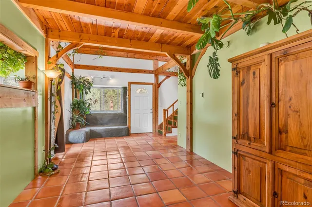 a view of a porch with wooden floor and furniture