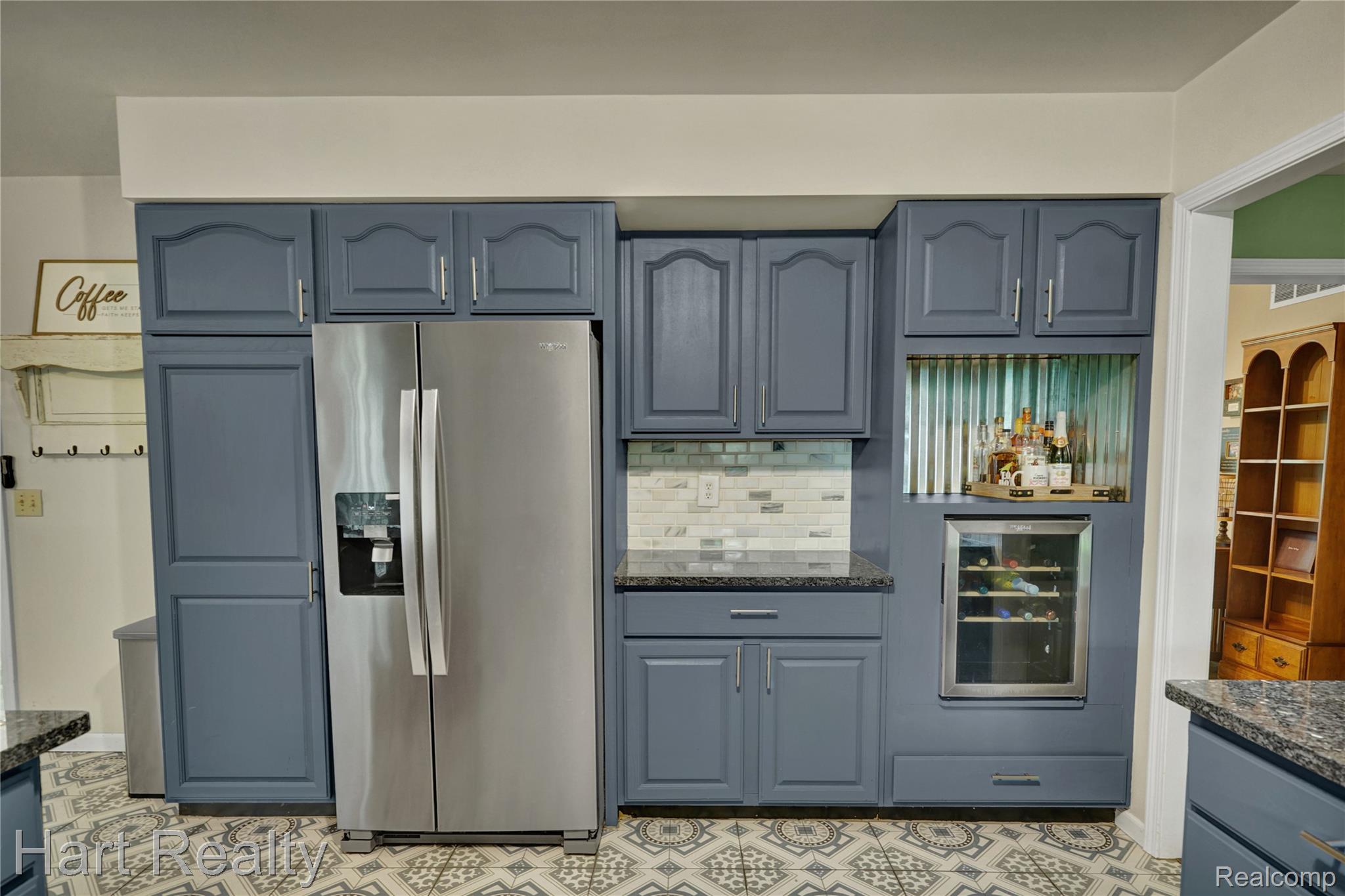 7167 Brown School Road North Branch, MI 48461 - Photo 18 of 51 Kitchen featuring extensive blue cabinetry with silver hardware, granite-style countertops, and patterned flooring