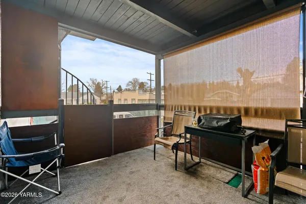 a view of a chairs and table in balcony