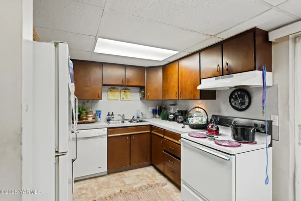 a kitchen with a stove a refrigerator and a sink