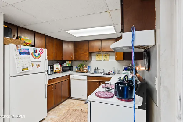 a kitchen with a refrigerator and a stove top oven