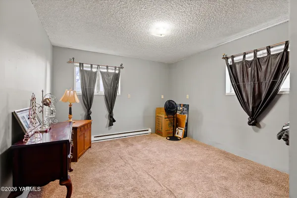 a view of a livingroom with furniture and a window