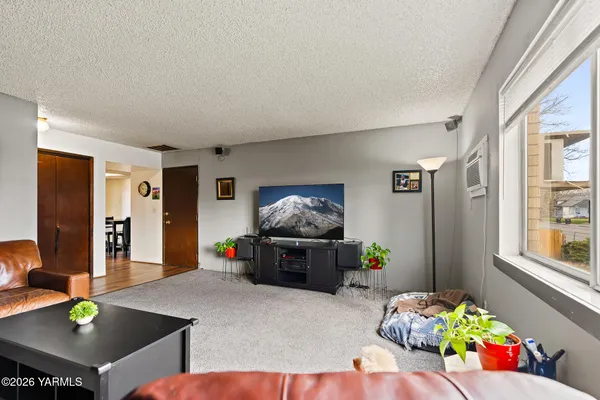 a living room with furniture and flat screen tv
