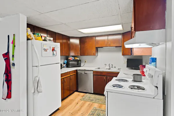 a white refrigerator freezer sitting inside of a kitchen