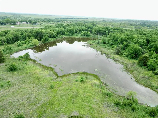 an aerial view of a house with a yard and garden