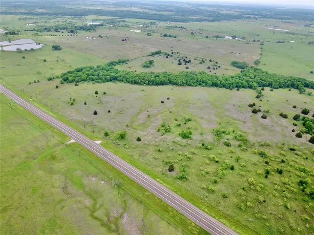 a view of a yard with a wooden fence