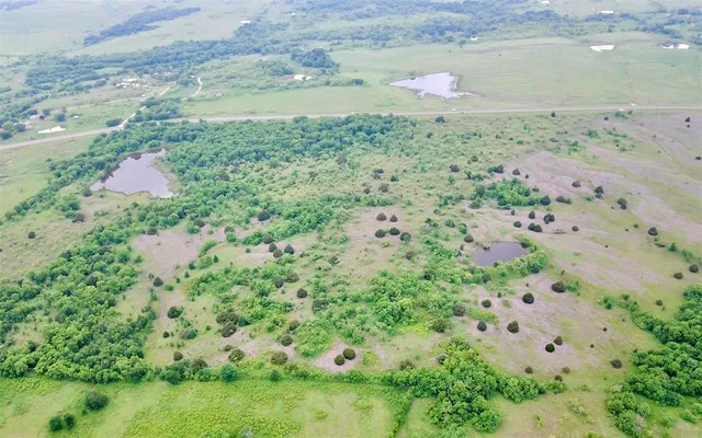 a view of a field with an ocean