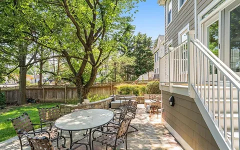 a view of a house with backyard porch and sitting area
