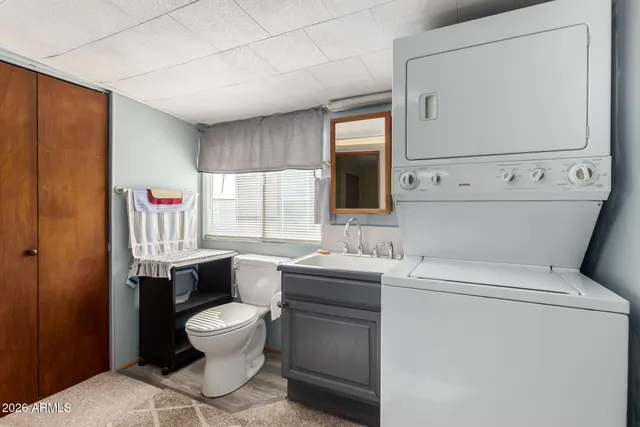a bathroom with a toilet sink and mirror