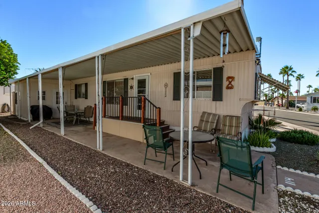 a view of a house with backyard and sitting area
