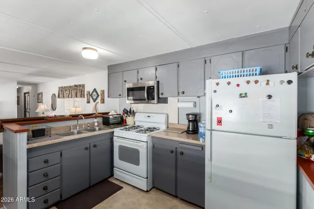 a kitchen with cabinets stainless steel appliances and sink