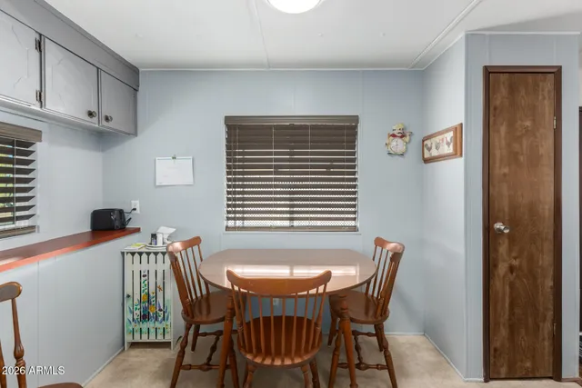 a view of a dining room with furniture and window