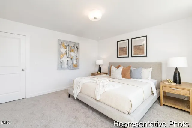 a bedroom with a bed and a painting on the wall