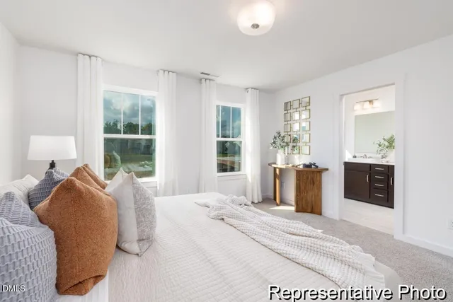 a bedroom with a large bed and a window