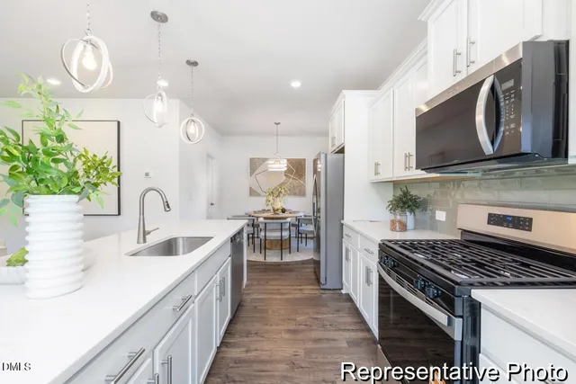 a kitchen with lots of counter space and stainless steel appliances