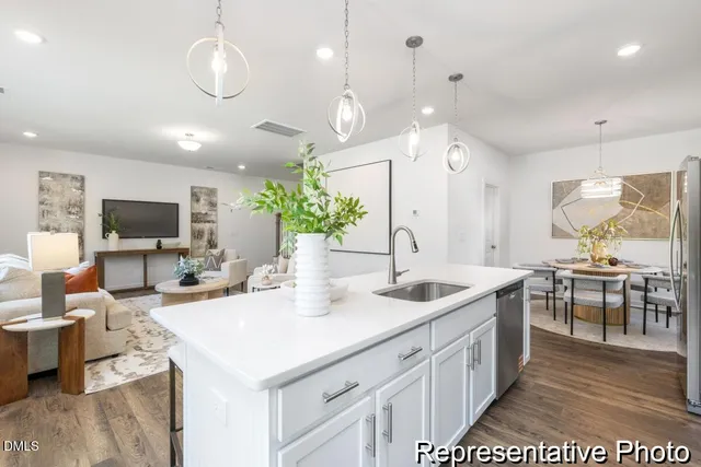 a large kitchen with kitchen island a sink dining table and chairs