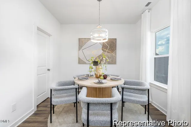 a dining room with furniture and window