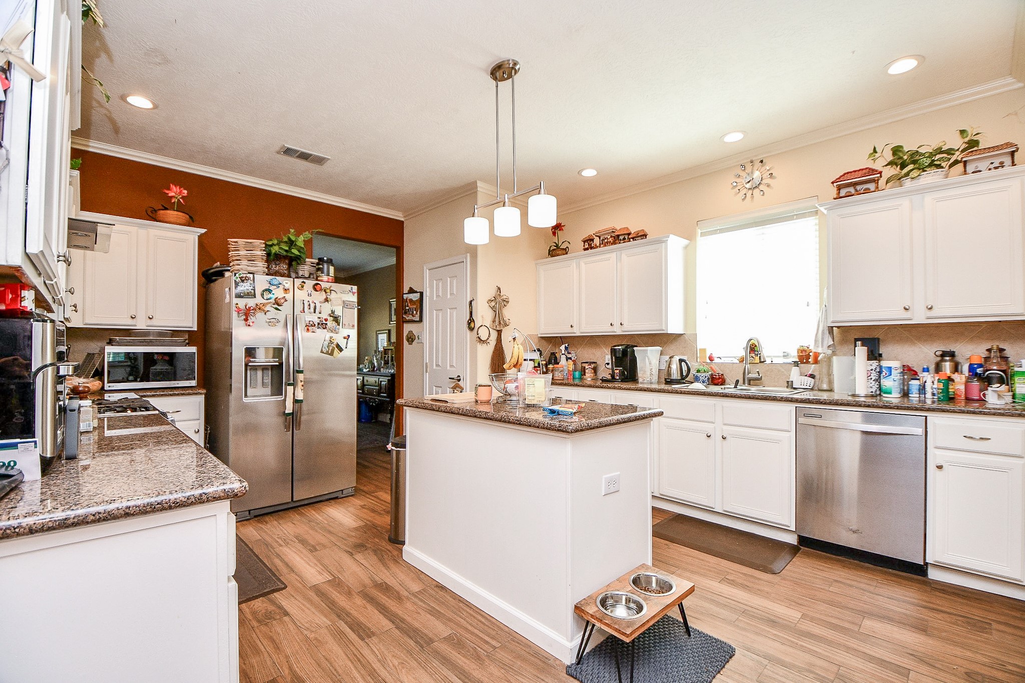 2910 Clayton Ridge Court Houston, TX 77082 - Photo 10 of 32 a kitchen with stainless steel appliances granite countertop a refrigerator a sink dishwasher a stove and white cabinets with wooden floor