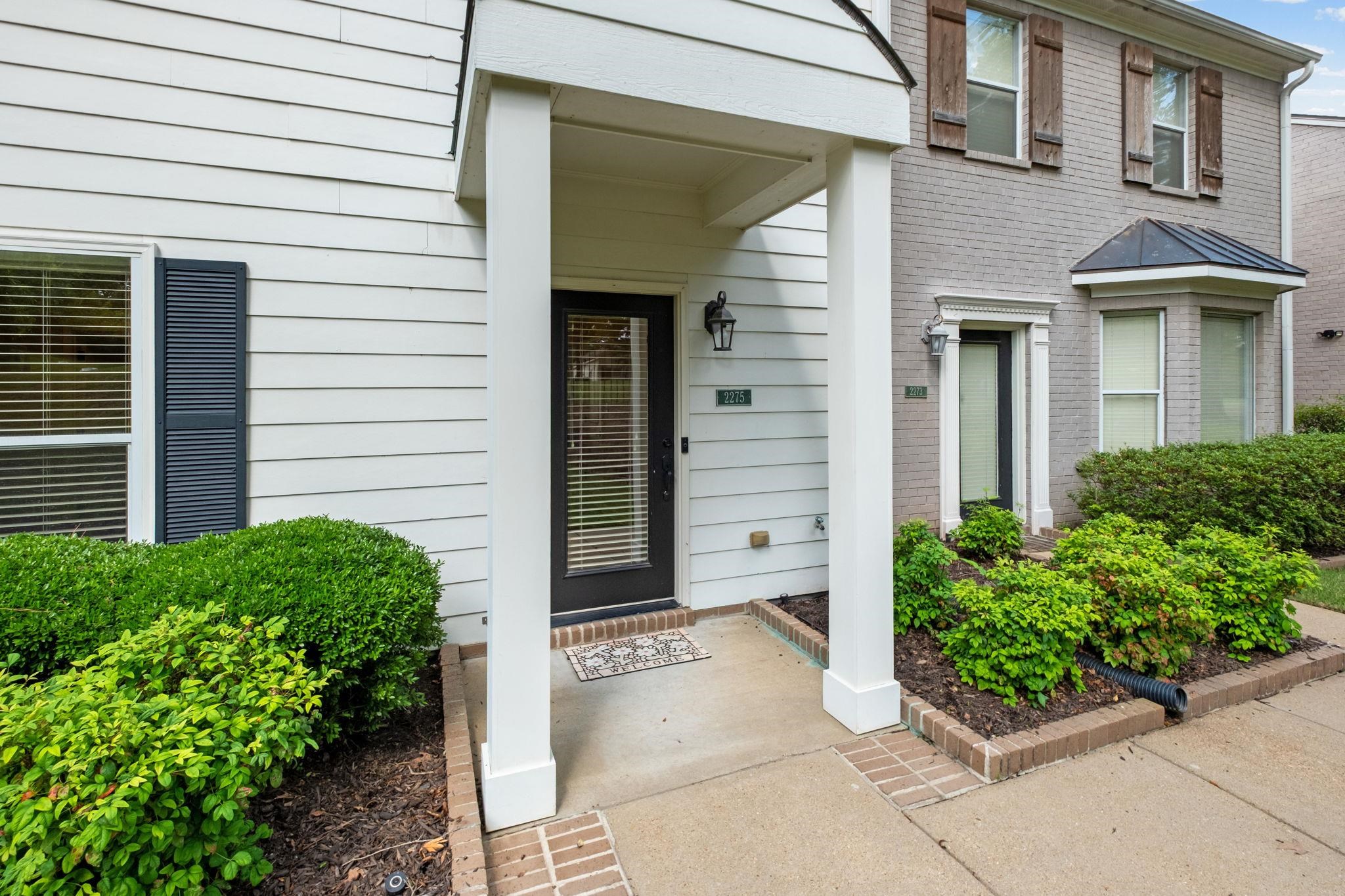 2275 McVay Road, Unit 2275 Germantown, TN 38138 - Photo 34 of 40 a view of a brick house with potted plants
