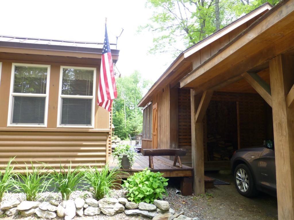 32 Bald Mt Road Oquossoc, ME 04964 - Photo 5 of 35 front entry, carport