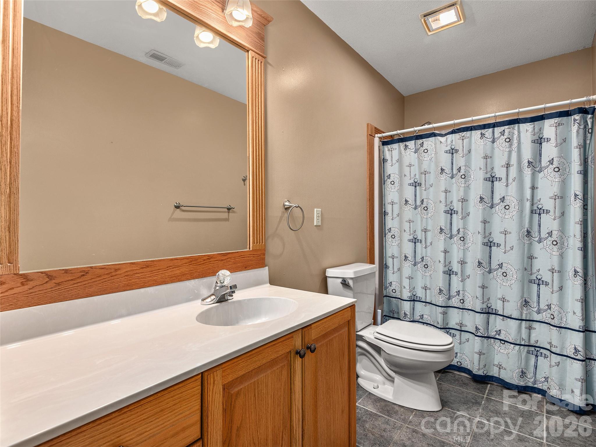 40 Deer Ridge Road Mills River, NC 28759 - Photo 19 of 35 a bathroom with a sink toilet and shower
