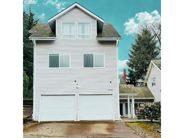 a view of a house with a yard and garage