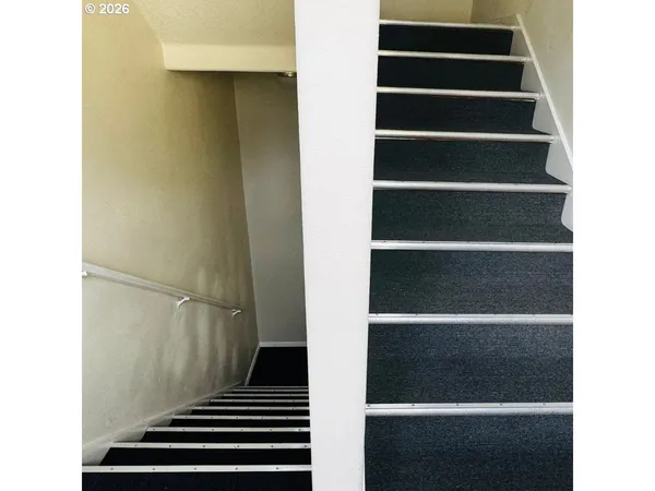 a view of staircase with white walls