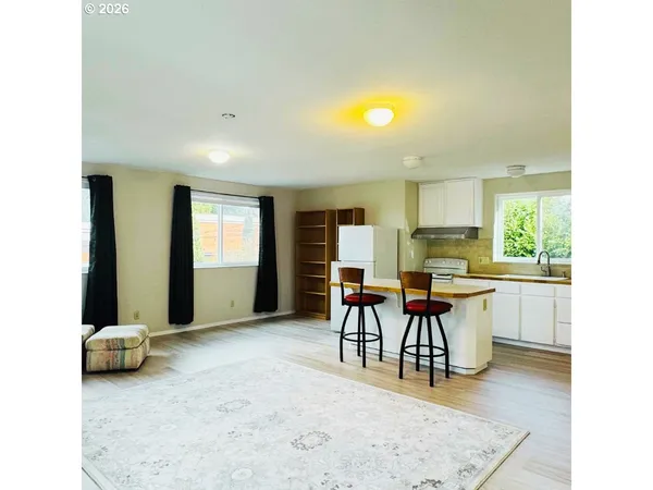 a view of a livingroom with furniture and a window