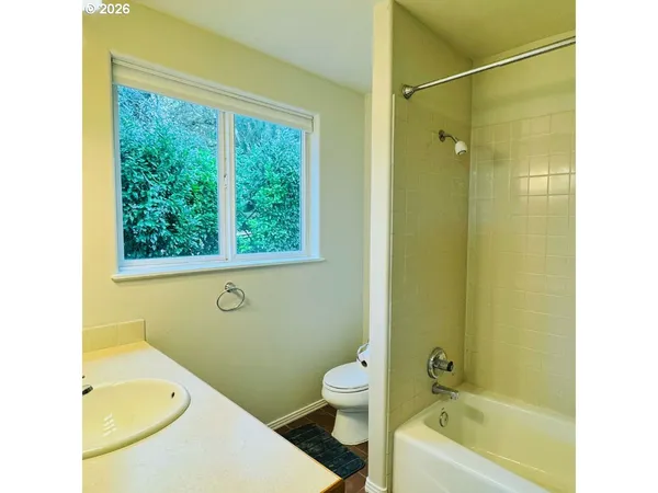 a bathroom with a toilet a sink and bathtub