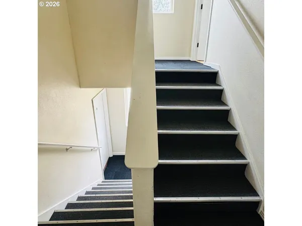 a view of staircase with wooden floor