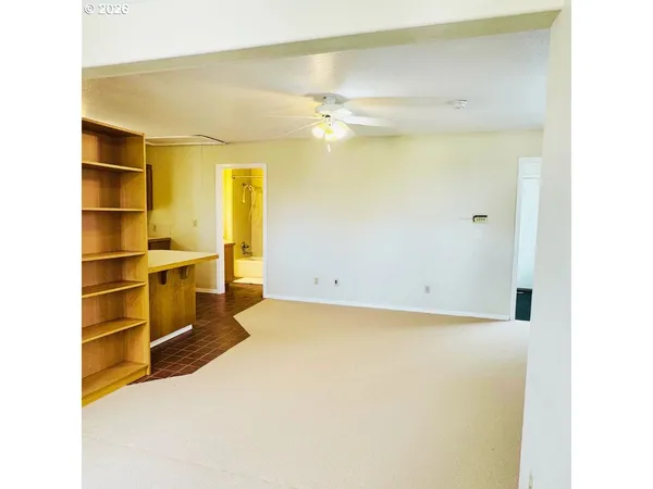 a view of a kitchen with a cabinet and a ceiling fan
