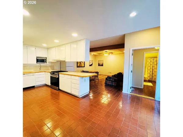 a view of a living room with furniture and a flat screen tv