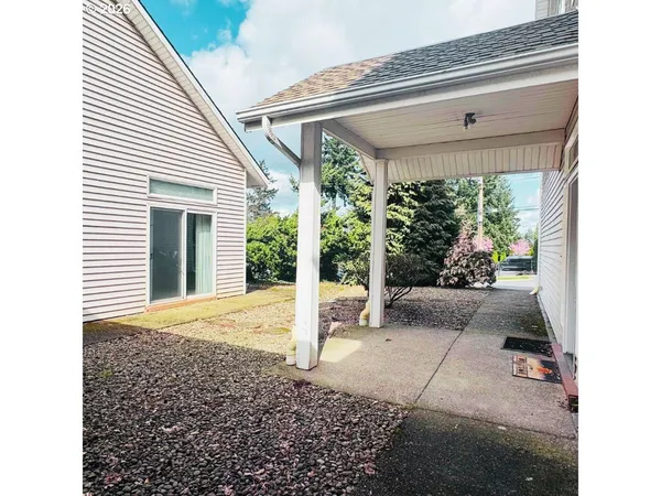 a view of a porch with a table and chairs and potted plants
