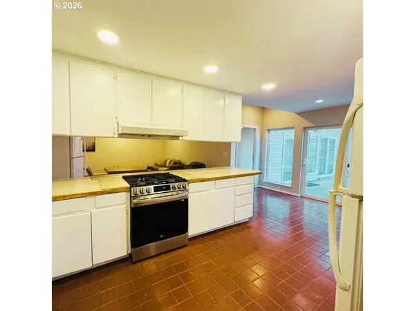 a kitchen with a stove a sink and a refrigerator