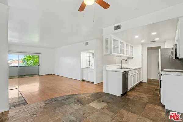 a view of a kitchen with a sink and a refrigerator